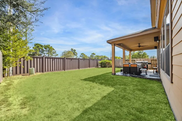 a view of a backyard with sitting area