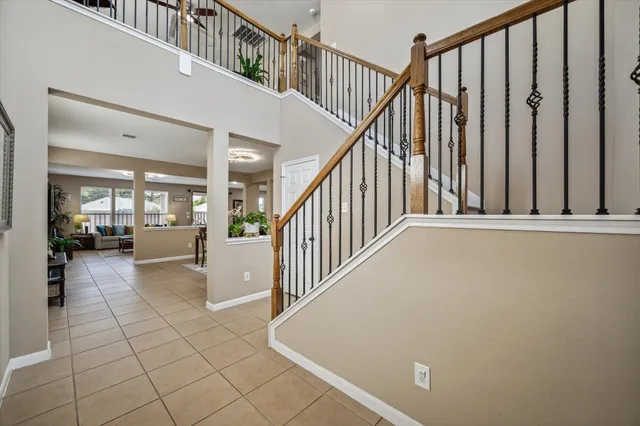 a view of staircase with lots of frames on wall and a view of staircase
