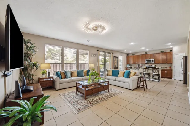 a living room with fireplace furniture and a flat screen tv