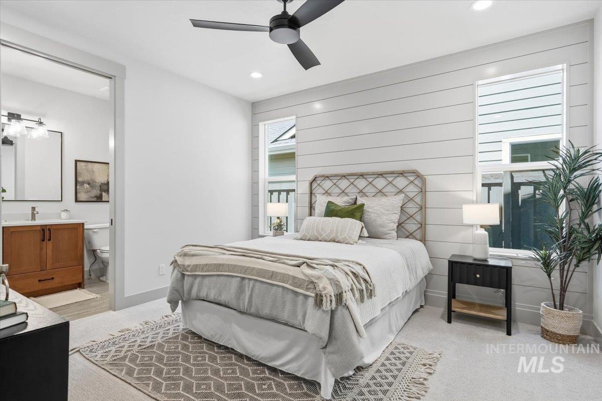 6762 South Messner Way Meridian, ID 83642 - Photo 26 of 35 Bedroom featuring a shiplap accent wall, two vertical windows, and a ceiling fan