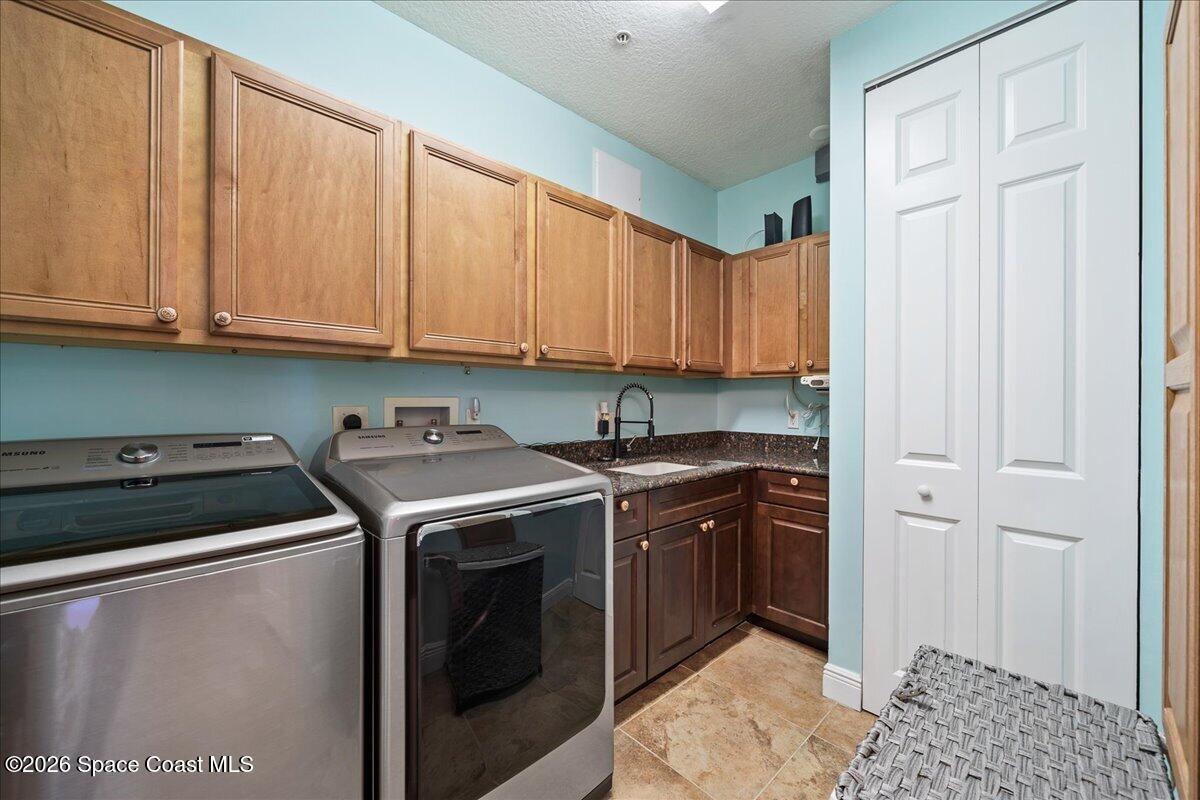 6005 Highway 1, Unit 101 Rockledge, FL 32955 - Photo 14 of 57 a kitchen with stainless steel appliances granite countertop a stove a sink and a refrigerator with wooden cabinets