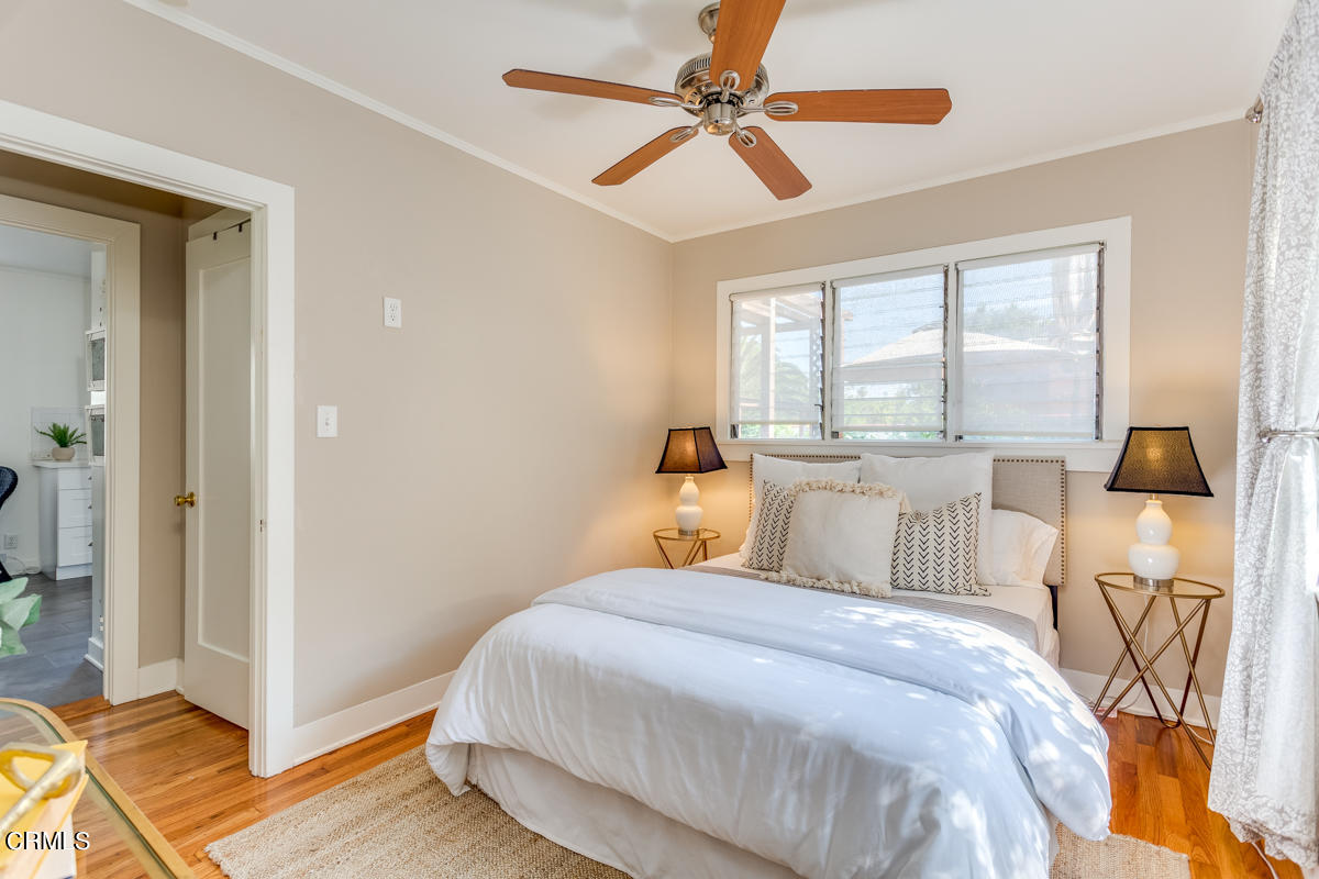 602 Atchison Street Pasadena, CA 91104 - Photo 19 of 34 a bedroom with a bed and wooden floor