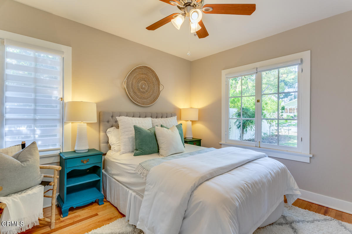 602 Atchison Street Pasadena, CA 91104 - Photo 20 of 34 a bedroom with a bed and a chandelier