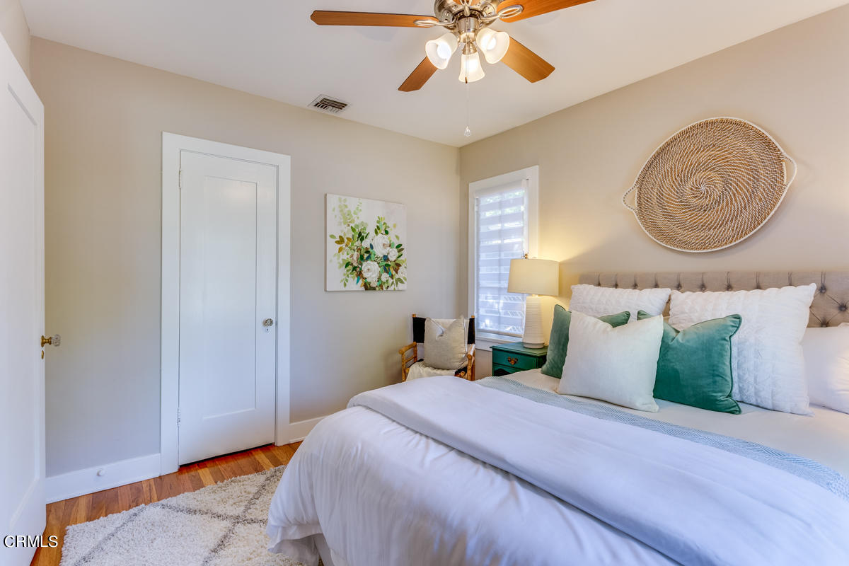 602 Atchison Street Pasadena, CA 91104 - Photo 21 of 34 a bedroom with a bed and a chandelier