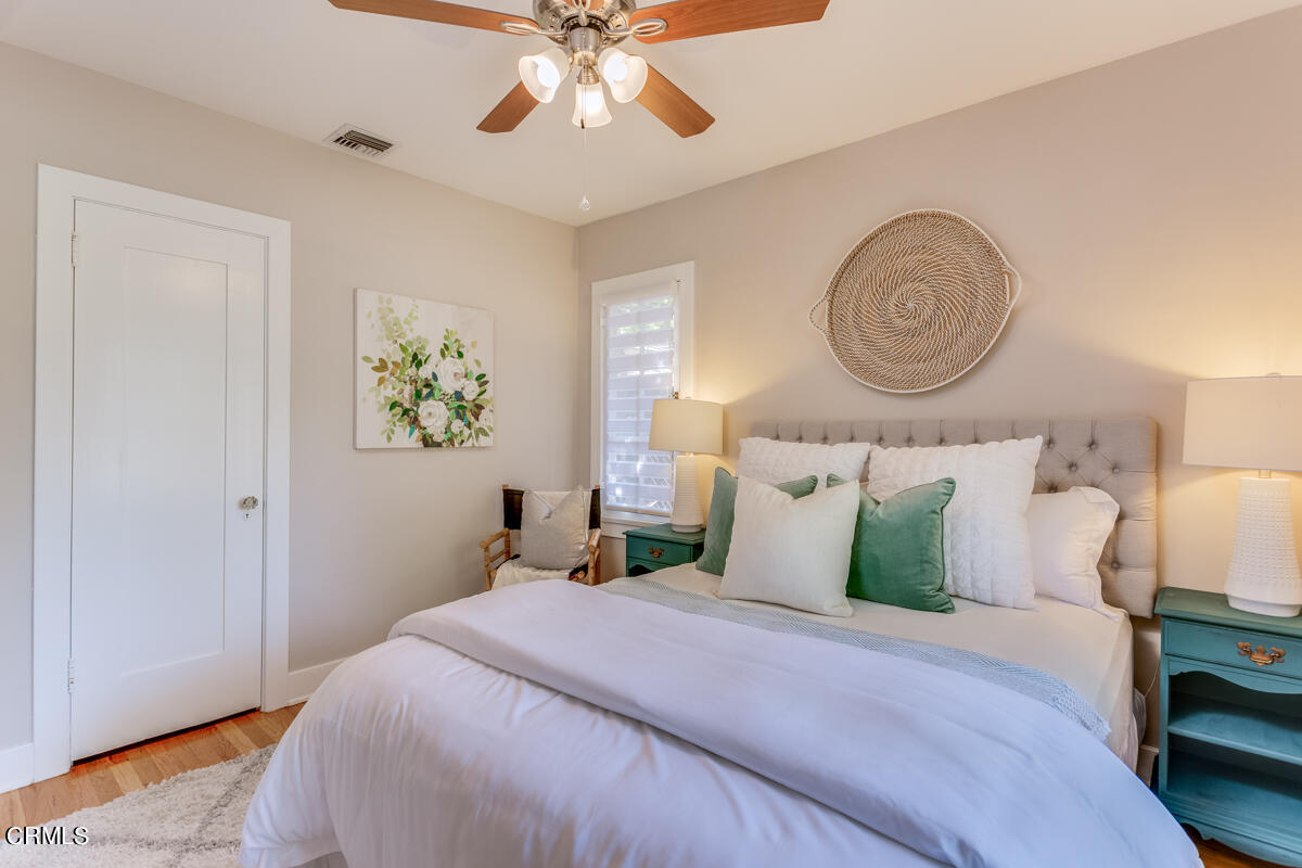 602 Atchison Street Pasadena, CA 91104 - Photo 22 of 34 a bedroom with a bed and a chandelier