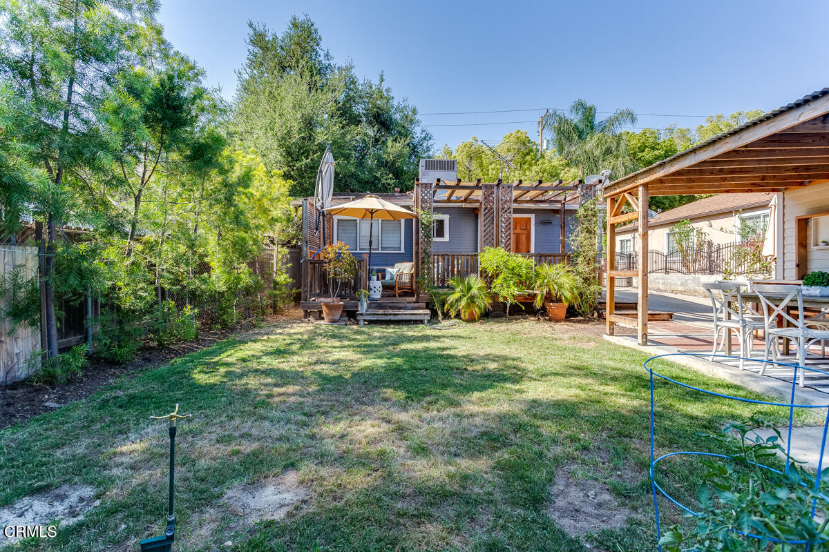 602 Atchison Street Pasadena, CA 91104 - Photo 29 of 34 a view of a backyard with table and chairs and potted plants