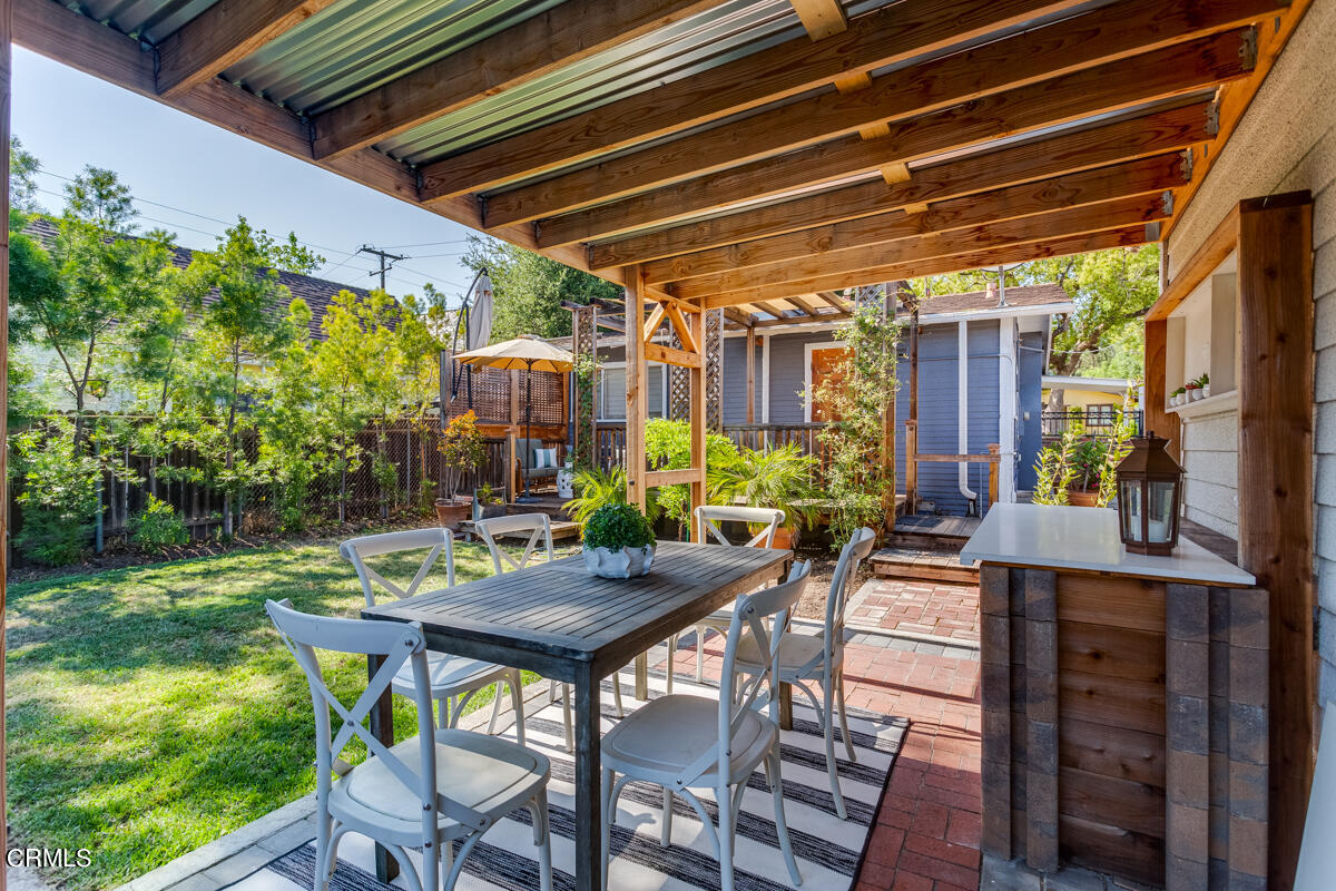 602 Atchison Street Pasadena, CA 91104 - Photo 31 of 34 a table and chairs in front of a house