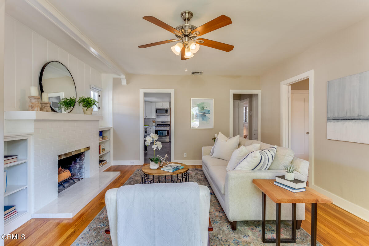 602 Atchison Street Pasadena, CA 91104 - Photo 7 of 34 a living room with furniture a fireplace and a table