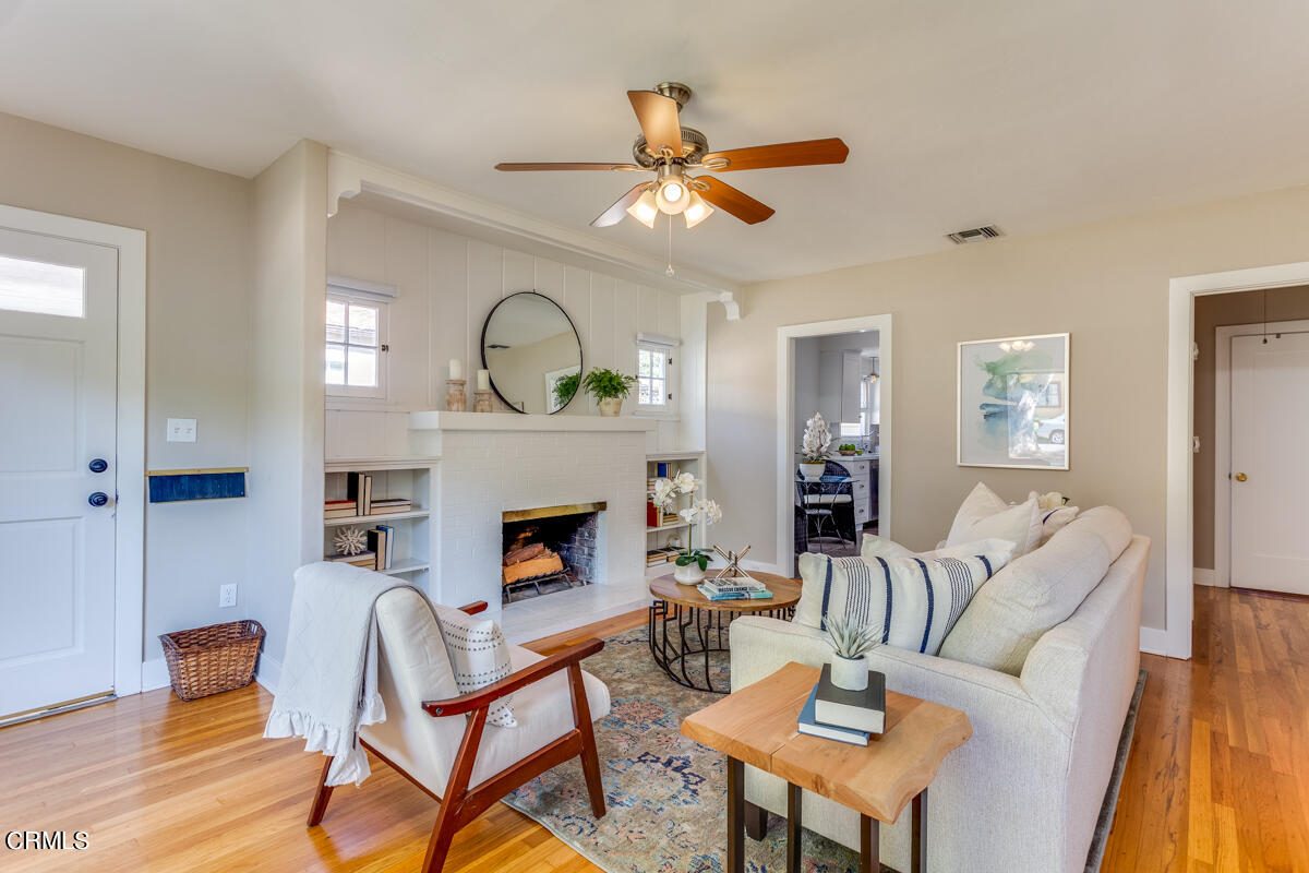 602 Atchison Street Pasadena, CA 91104 - Photo 8 of 34 a living room with furniture a fireplace and wooden floor