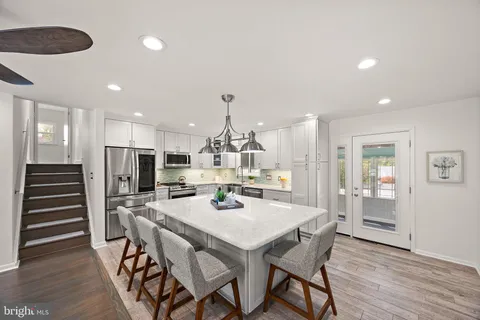 a dining room with furniture and wooden floor