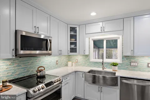 a kitchen that has a sink and a stove in it