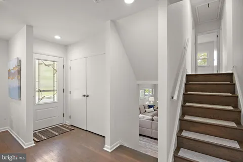 a view of an entryway with wooden floor and windows