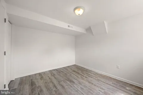 a view of room with wooden floor and window