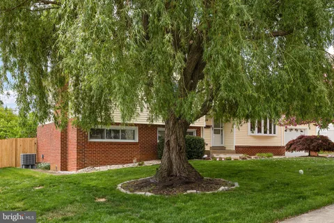a front view of a house with a garden and yard