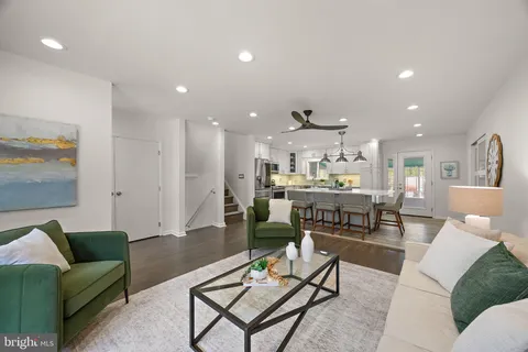 a living room with furniture and kitchen view