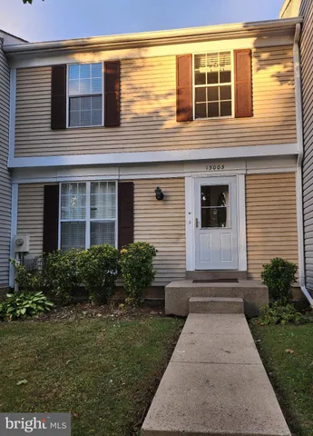 a view of house with backyard space and garden