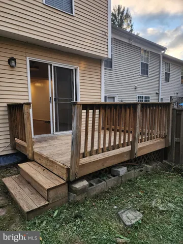 a view of a house with backyard and wooden fence