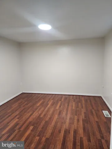 a view of an empty room and wooden floor