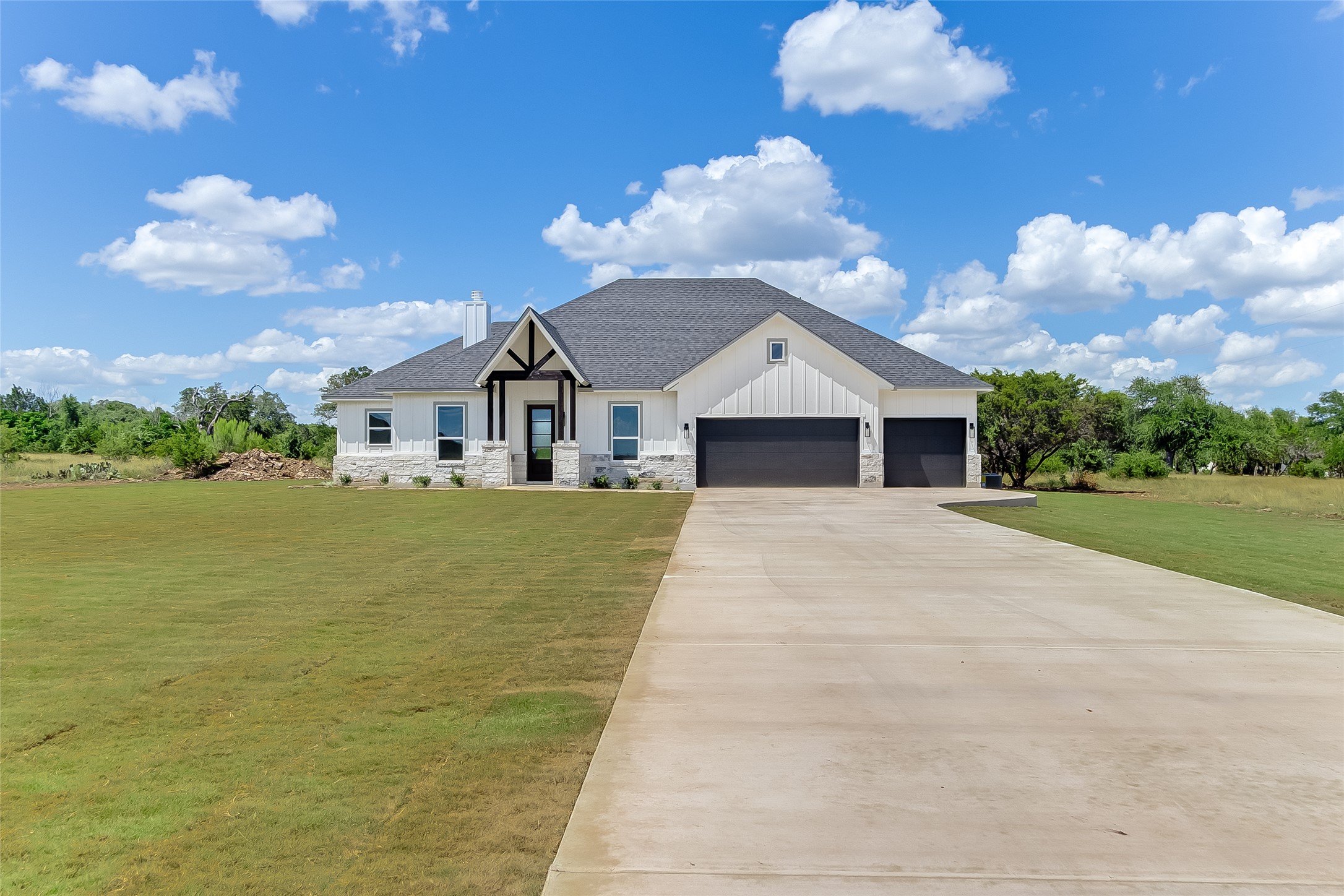130 Draper Lane Bertram, TX 78605 - Photo 1 of 31 a front view of a house with a yard and potted plants