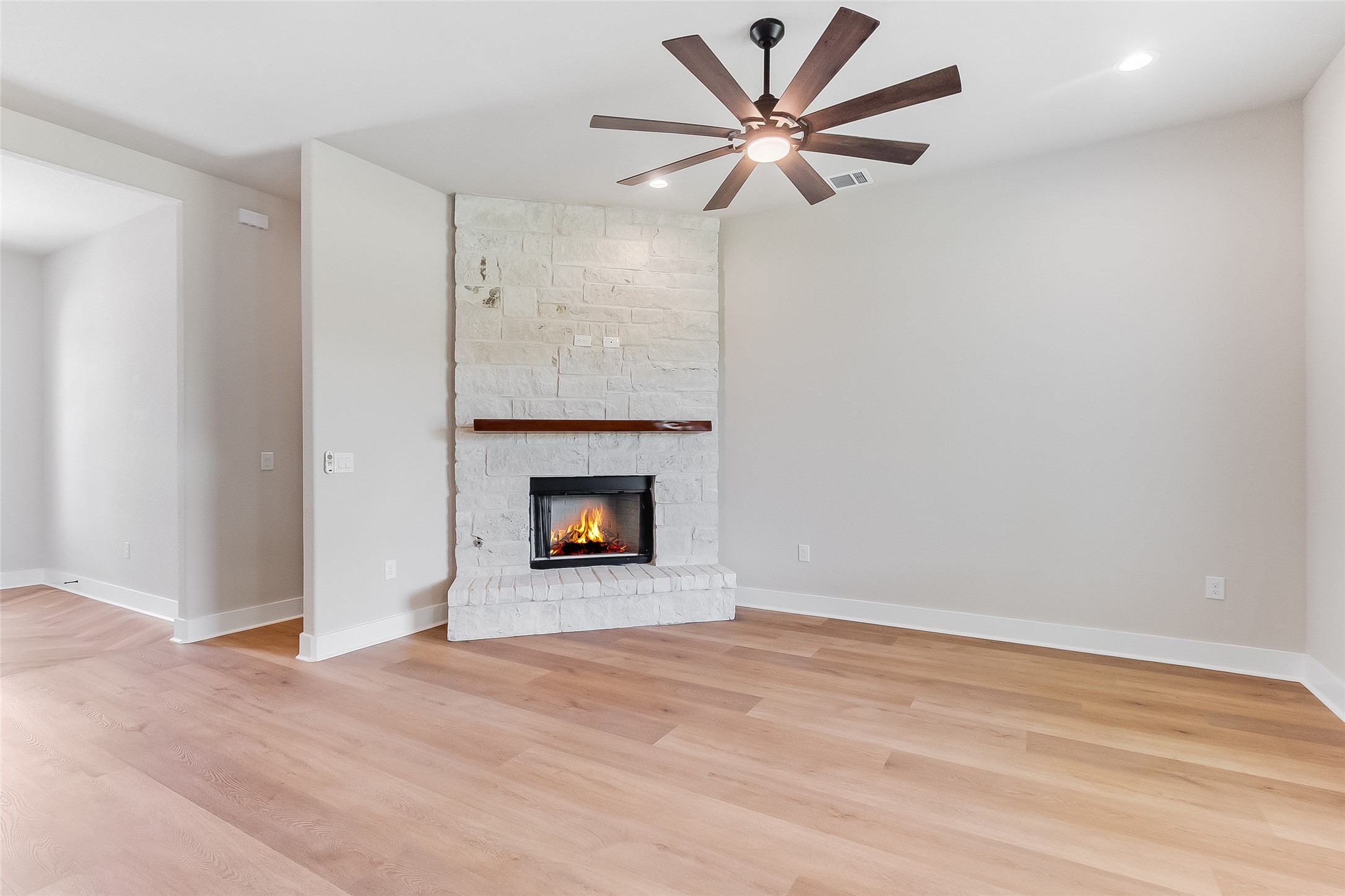 130 Draper Lane Bertram, TX 78605 - Photo 12 of 31 wooden floor in an empty room with a fireplace