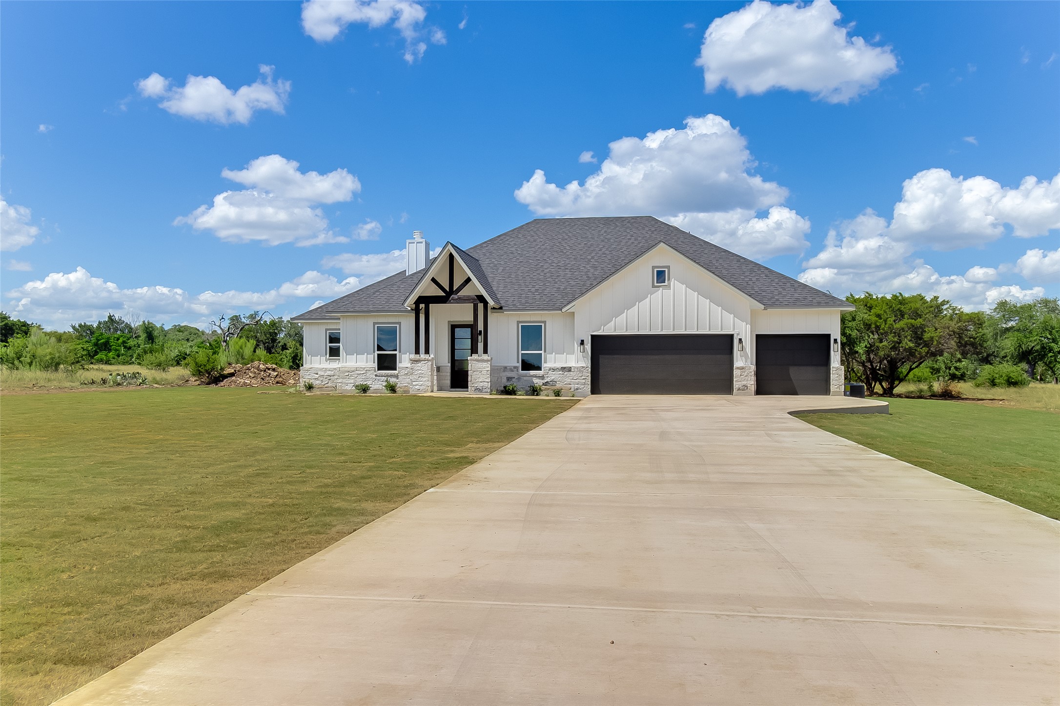 130 Draper Lane Bertram, TX 78605 - Photo 2 of 31 a front view of a house with a yard and garage