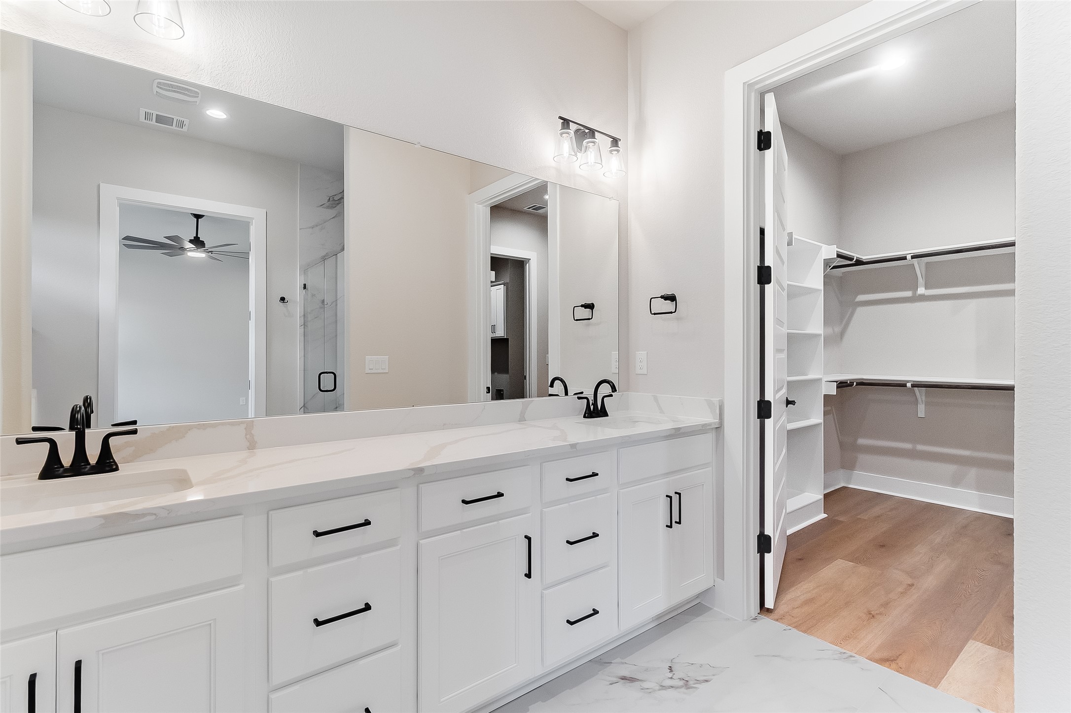 130 Draper Lane Bertram, TX 78605 - Photo 24 of 31 a bathroom with a double vanity sink mirror double and shower