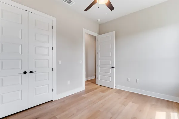 an empty room with closet area