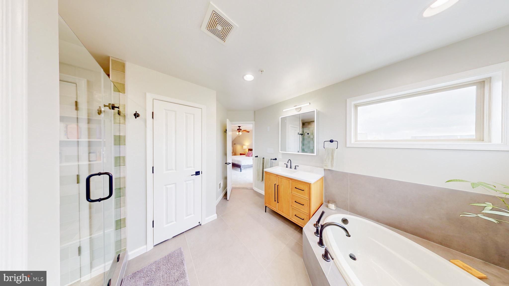 13227 Deer Highlands Way Silver Spring, MD 20906 - Photo 15 of 20 a bathroom with a tub sink and mirror