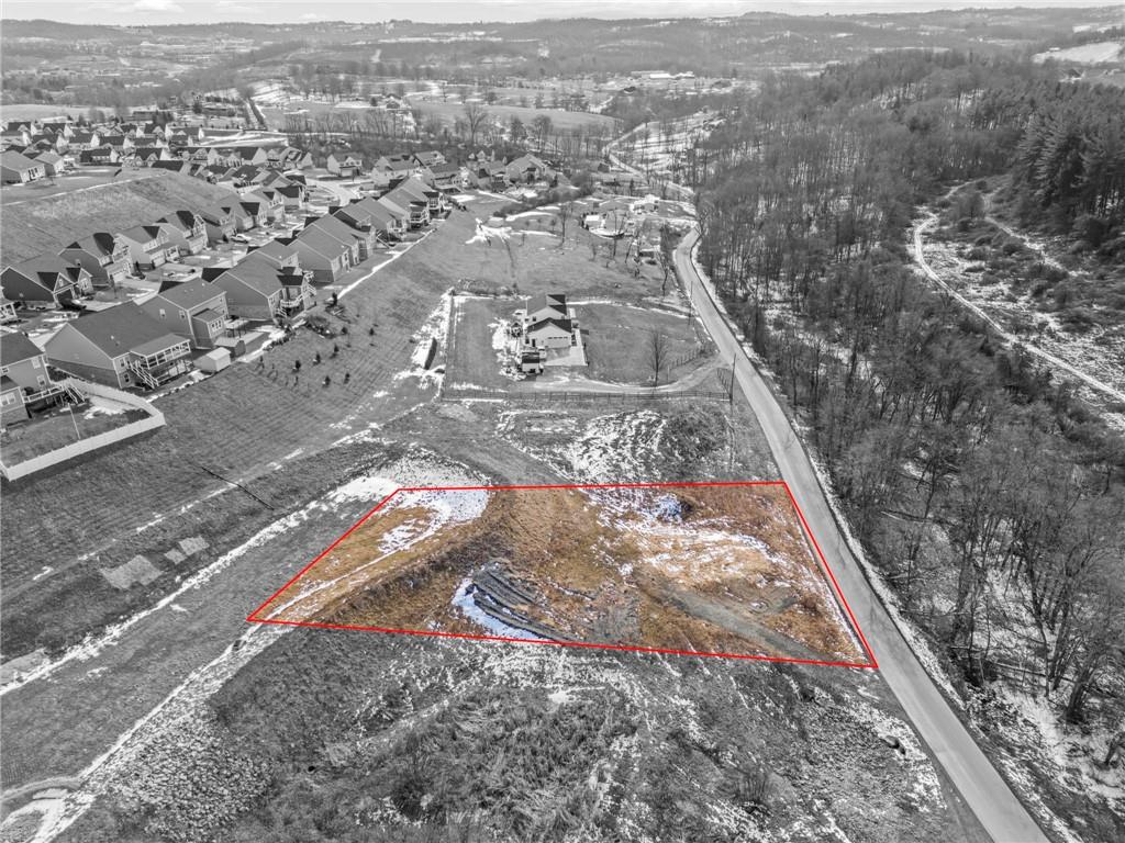 an aerial view of residential houses with city view