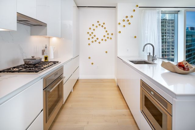 a kitchen with sink a stove and refrigerator