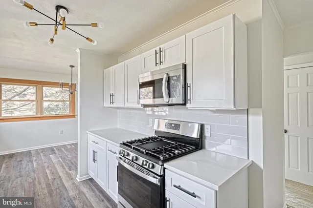 a kitchen with a stove and a refrigerator