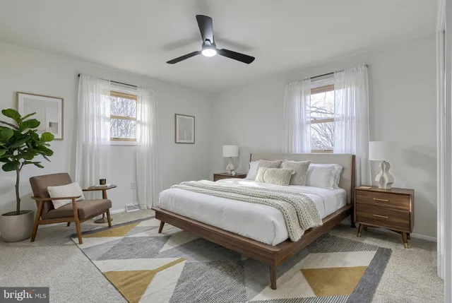 a living room with hard wood floors and a fireplace
