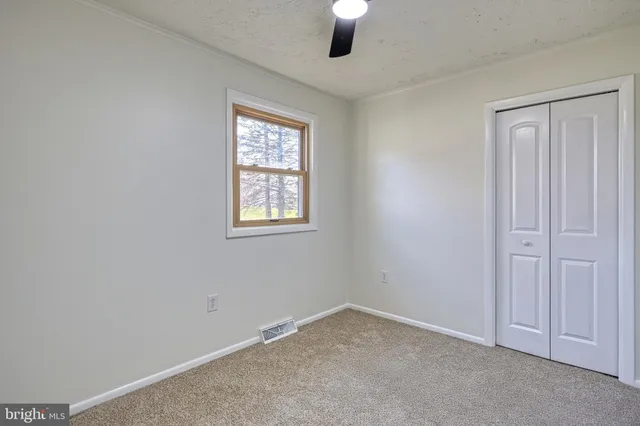 a view of a backyard with wooden fence
