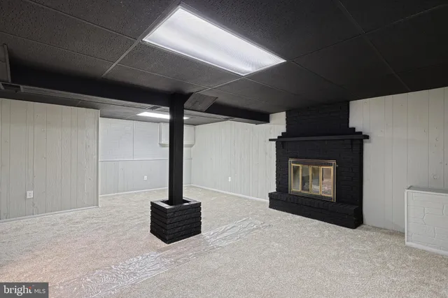 an aerial view of a house with a yard basket ball court and outdoor seating
