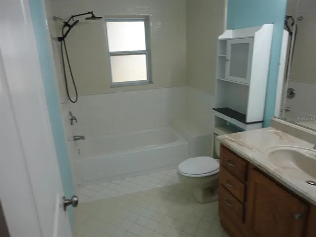 a bathroom with a granite countertop toilet sink and shower