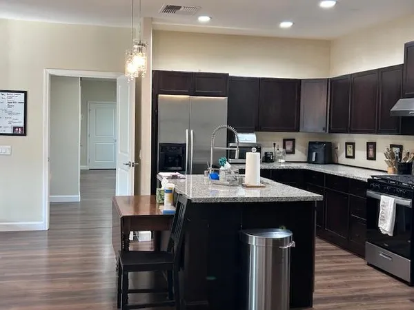 a kitchen with a sink cabinets and wooden floor