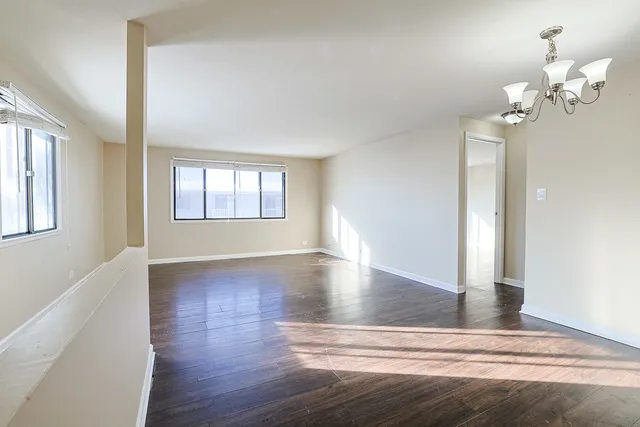 a view of a room with wooden floor and staircase