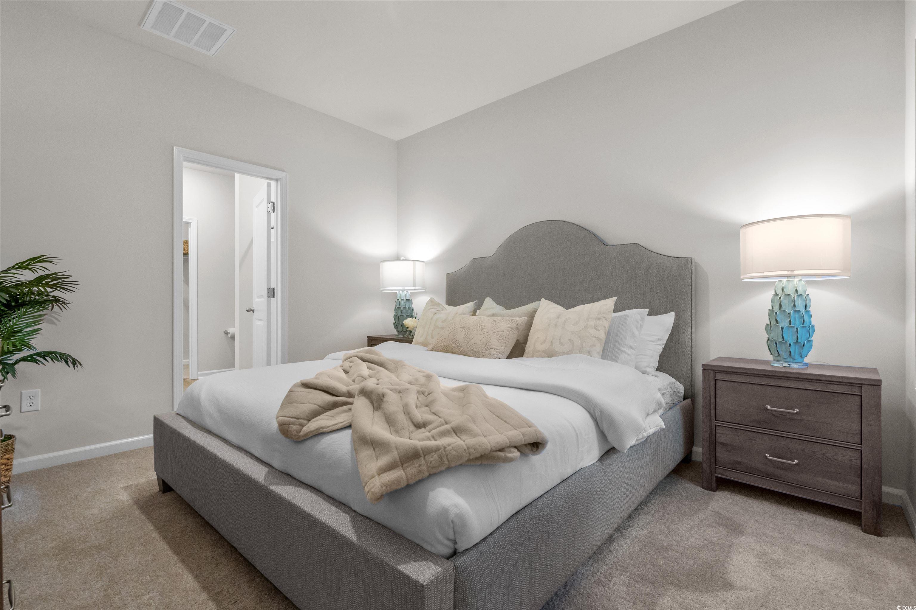 814 Palm Frond Way, Unit 42 Calabash, NC 28467 - Photo 14 of 31 Primary bedroom on main level, 36" tall cabinet with double sink, walk in closet, comfort height toilet, 5' shower stall