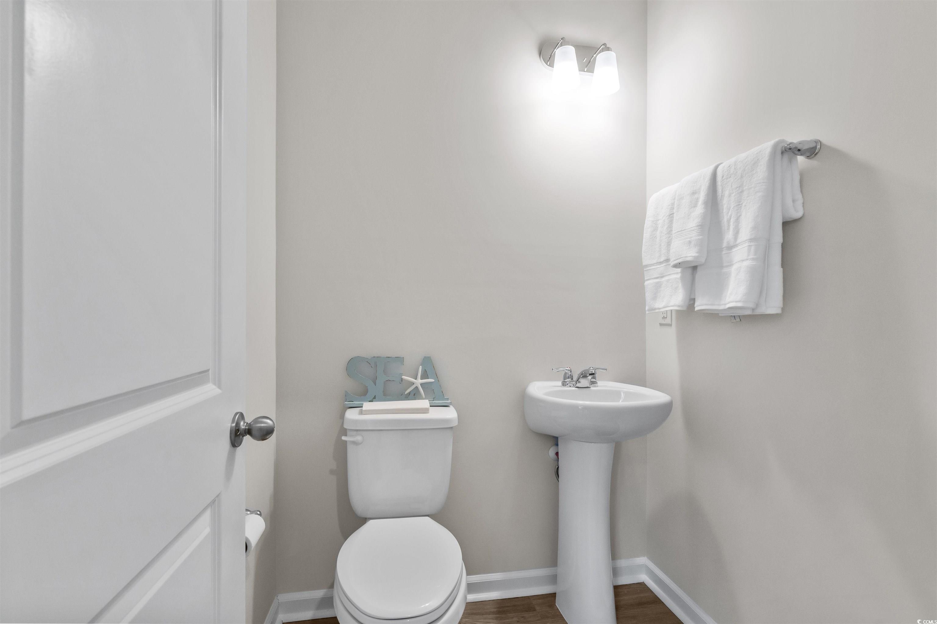 814 Palm Frond Way, Unit 42 Calabash, NC 28467 - Photo 20 of 31 Half bathroom with LVP flooring and comfort height toilet