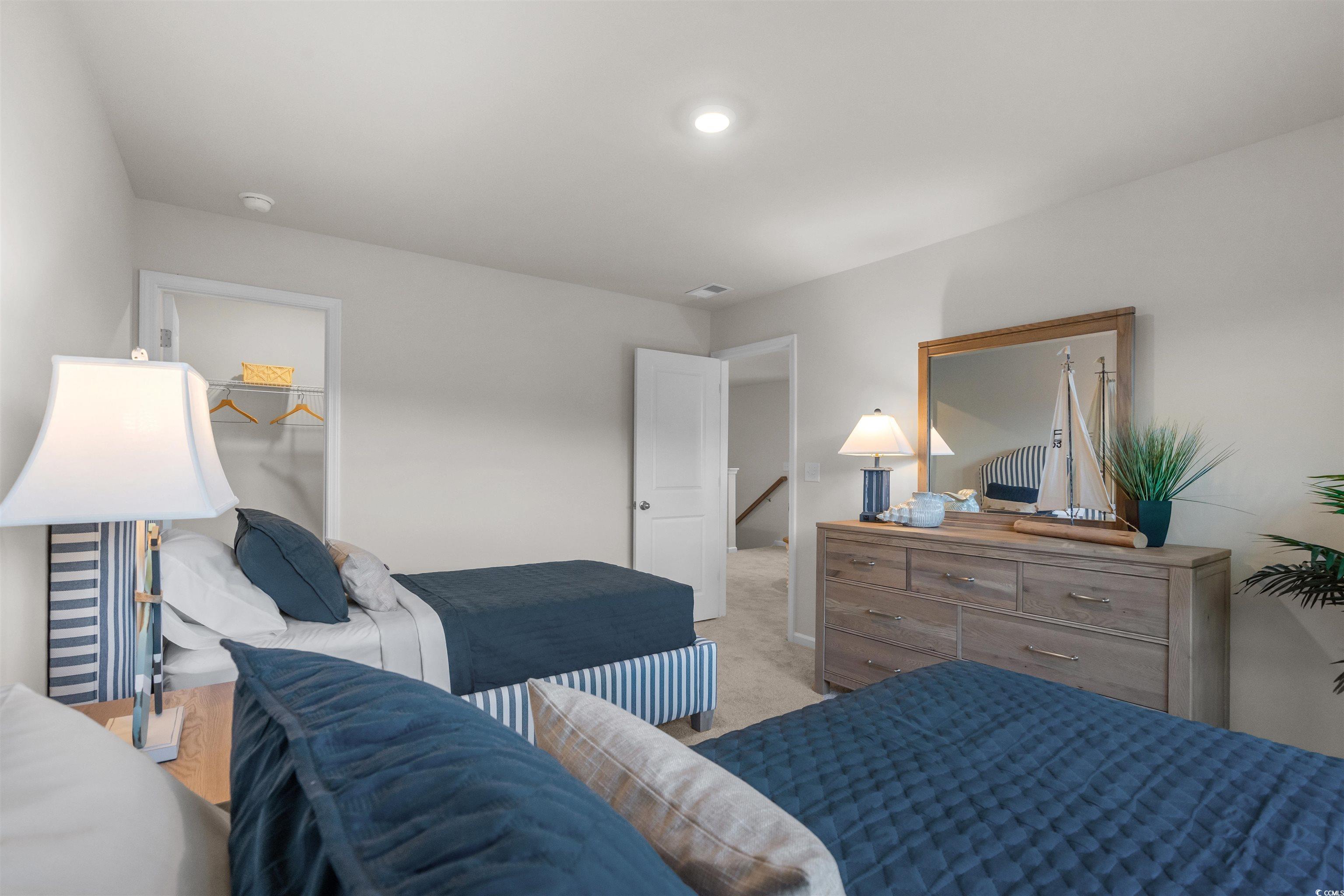 814 Palm Frond Way, Unit 42 Calabash, NC 28467 - Photo 29 of 31 Bedroom featuring carpet flooring and a spacious closet