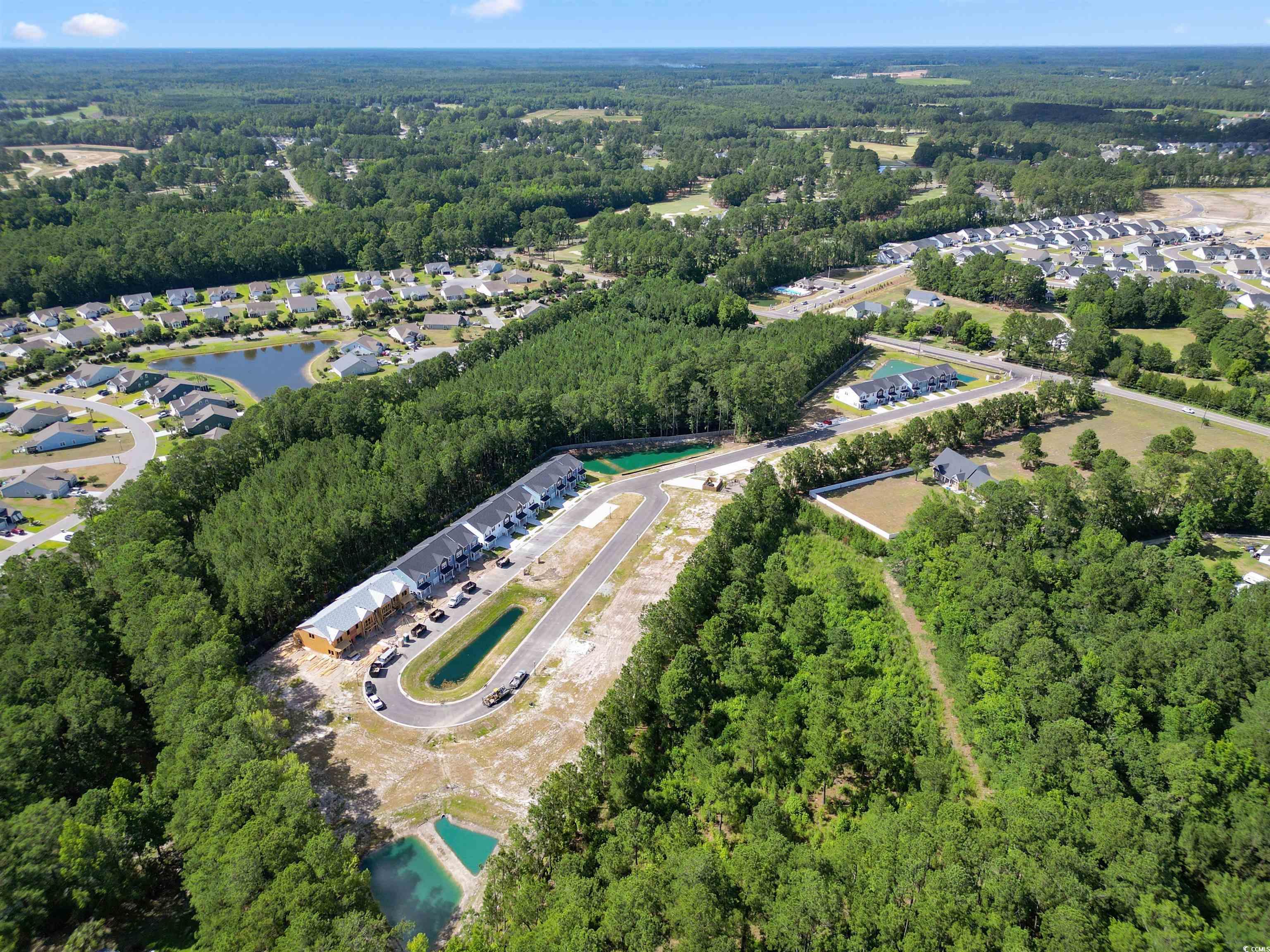 814 Palm Frond Way, Unit 42 Calabash, NC 28467 - Photo 3 of 31 Aerial overview of property's location with a forest and nearby suburban area