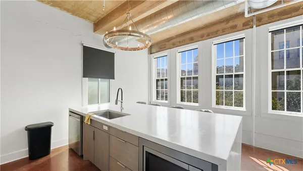 a kitchen with a sink and a refrigerator
