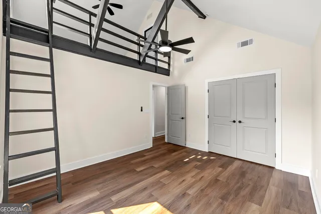 a view of a room with wooden floor