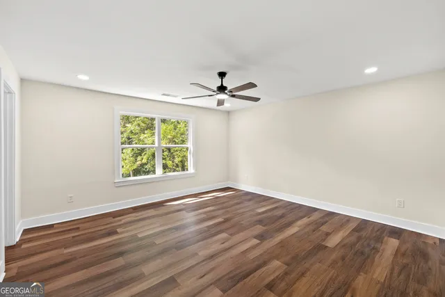 wooden floor in an empty room with a window