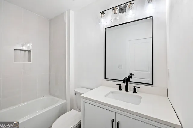 a bathroom with a sink toilet and vanity