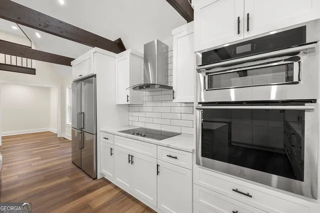 a kitchen with granite countertop a stove and a microwave