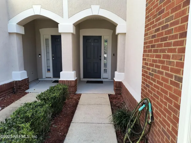 a view of a pathway with a house in the background