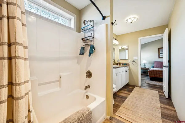 a bathroom with a bathtub a sink and a shower