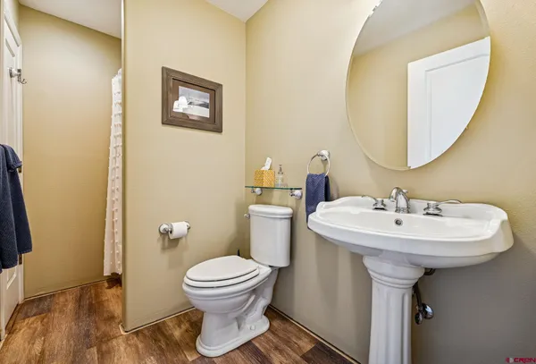 a bathroom with a sink toilet and a mirror