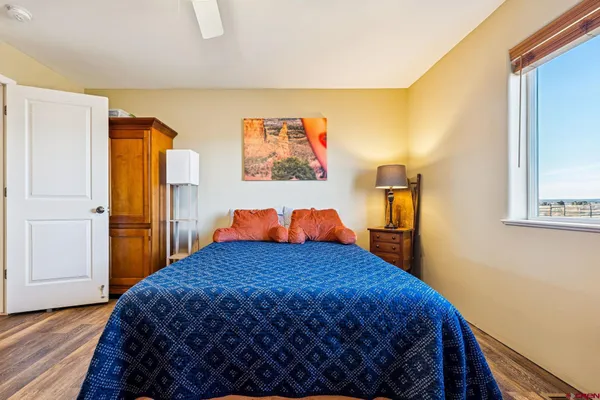 a bedroom with a bed and a painting on the wall